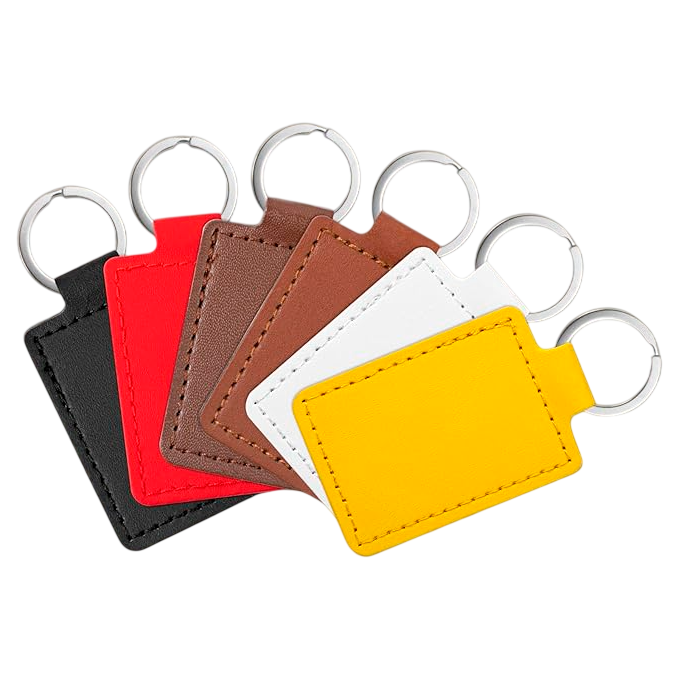 Set of five leather keychains in black, red, brown, white, and yellow on a white background.