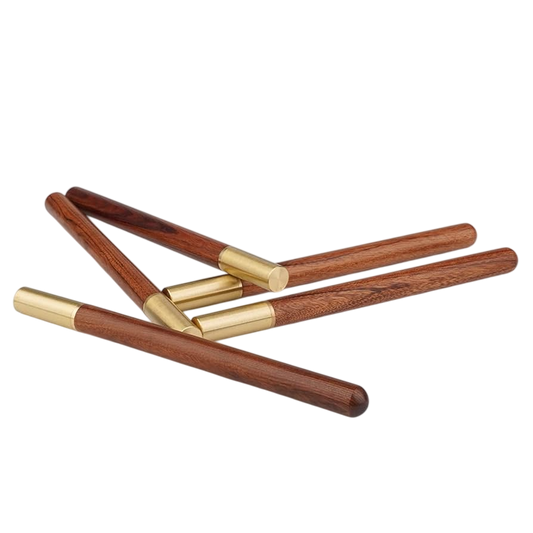 Set of wooden sticks with gold accents on a white background