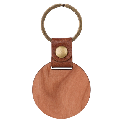 Brown leather keychain with a round wooden tag and gold accent on a white background