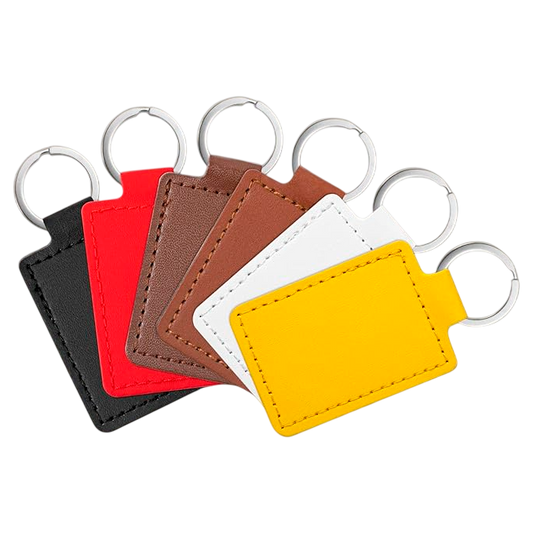 Set of five leather keychains in black, red, brown, white, and yellow on a white background.
