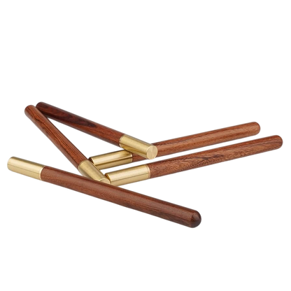 Set of wooden sticks with gold accents on a white background
